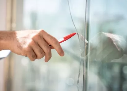 Hand Pointing to Broken Window