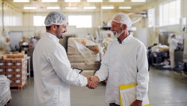 PA and Food Plant Manager Shaking Hands 1200179893